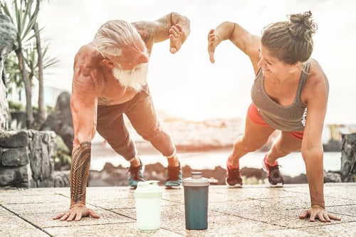 Preview: Couple Of Fitness Athlete Doing Push-Ups Workout Sessions Outdoor At Sunset - Happy Trendy Athlete