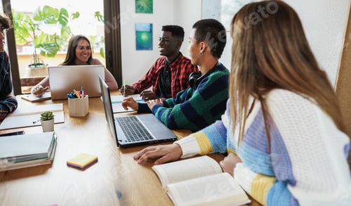 Preview: Multiracial Students Reading Books And Using Laptop While Studying Together - School Concept