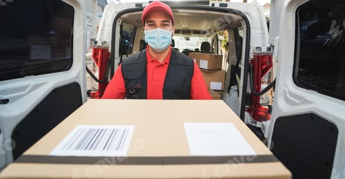 Preview: Courier Delivering Packages With Truck While Wearing Protective Face Mask For Coronavirus