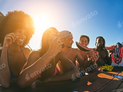 Preview: Happy Multiracial Friends Eating Watermelon While Doing Sea Tour With Sailing Boat - Soft Focus On