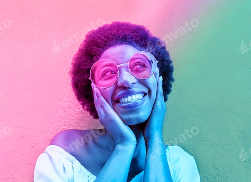 Preview: Smiling Woman Wearing Round Glasses in Colorful Lighting