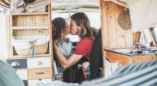 Preview: Happy Man And Woman Kissing Inside Vintage Minivan - Travel Couple Having Tender Moments During
