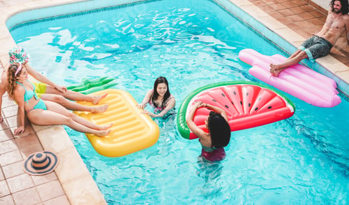 Preview: Happy Friends Floating With Air Lilo Ball At Swimming Pool Party - Young People Having Fun On