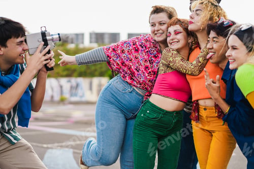 Preview: Young Diverse People Having Fun With Old Vintage Video Camera Outdoor - Focus On Girl With Eye