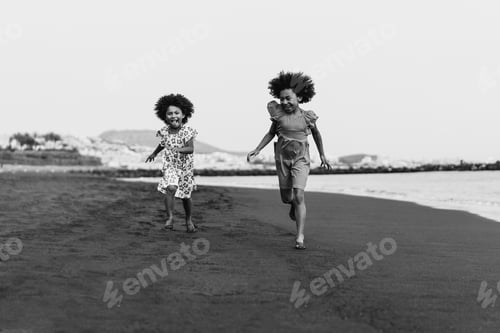 Preview: Happy African Sister Twins Running On The Beach Together During Summer Time - Main Focus On Right
