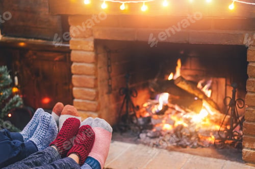 Preview: Legs View Of Happy Family Lying Down Wearing Warm Wool Socks With Fire Place And Vintage Lights In