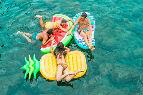 Preview: Happy Friends Floating With Lilos Mattress Inside Sea Natural Pool - Young Trendy People Having Fun