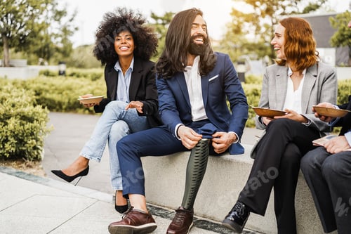 Preview: Diverse Business People Doing Lunch Break Outdoor From Office Building - Focus On Man Face With Leg