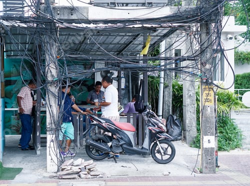 Preview: Phuket,Thailand - January 10, 2016:Messy Electrical Cables In Patong - Example Of Uncovered Optical