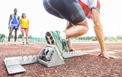 Preview: Runner Using Starting Block To Start His Run On Race Track - Young Athlete Starting His Sprint On