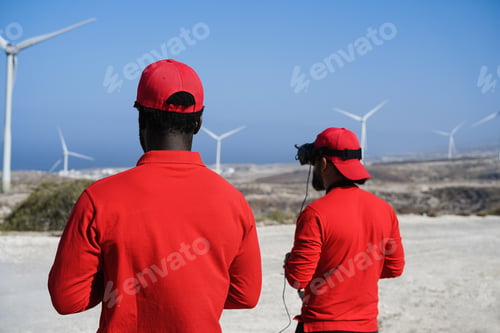 Preview: Engineers Using Virtual Reality Headset While Working At Windmill Farm - Focus On African Man Head