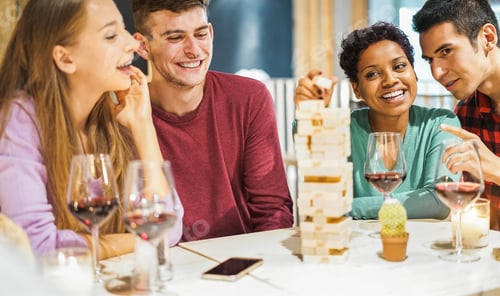 Preview: Friends Playing Tabletop Game with Drinks and Laughter