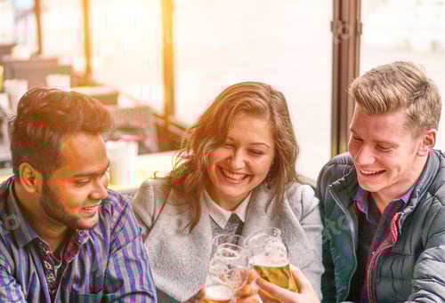 Preview: Multiracial Best Friends Drinking A Beer Together Sitting In Bar - Happy People Having Fun Together