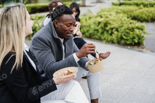 Preview: Multiethnic Business People Doing Lunch Break Outdoor From Office Building - Focus On African Man