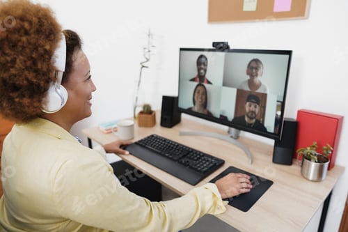 Preview: African Woman Having Video Call With Her Colleagues Using Computer App - Soft Focus On Right Hand