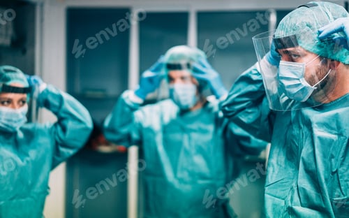 Preview: Doctors And Nurse Preparing To Work In Hospital For Surgical Operation During Coronavirus Pandemic