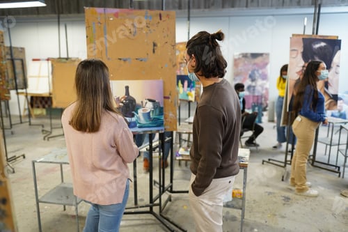 Preview: Young Students Painting Inside Art Room Class At College - Focus On Guy Head