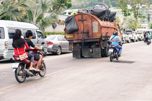 Preview: Phuket - February 12:Taxi Scooter Passing A Garbage Track On Thailand Road,February 12, 2016
