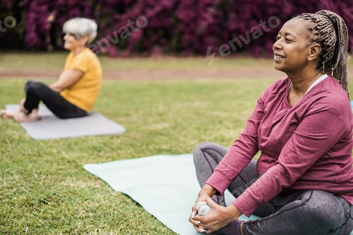 Preview: Senior People Doing Yoga Class Keeping Distance At City Park - Focus On African Woman Face