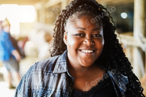 Preview: Portrait Of Young African Farmer Woman Working Inside Cowshed - Focus On Face