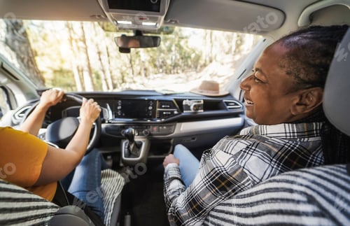 Preview: Multiracial Senior Women Having Fun On The Road In Camper Van - Focus On Afican Female Eye