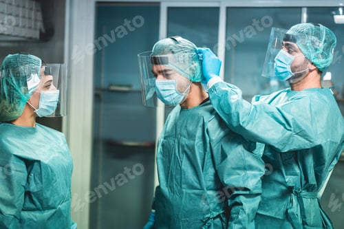 Preview: Doctors And Nurse Preparing To Work In Hospital For Surgical Operation During Coronavirus Pandemic
