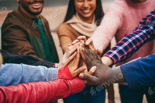 Preview: Young Diverse Team Having Fun Stacking Hands Outdoor - Focus On Hands
