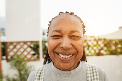 Preview: Senior African Woman Smiling On Camera Outdoor - Main Focus On Nose
