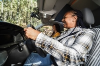 Preview: Multiracial Senior Friends Having Fun On The Road With Mini Van Camper - Focus On African Woman Face