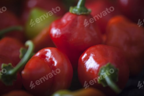Preview: Sweet Red Pepper In A Dark Basket Over A Rustic Wooden Table