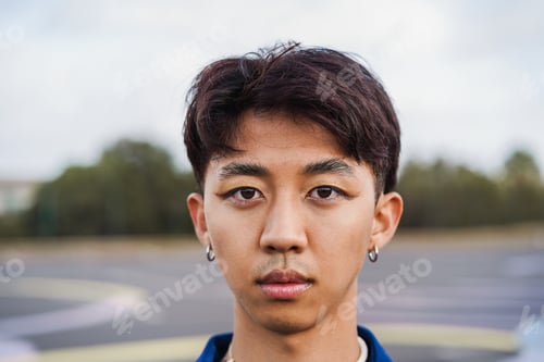 Preview: Young Gay Asian Man With Makeup On Looking At Camera Outdoor - Focus On Face