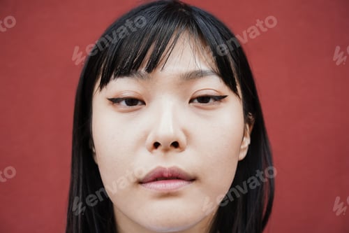 Preview: Young Asian Girl Looking At Camera Outdoor - Focus On Face