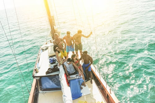 Preview: Group Of Young People Drinking And Dancing In Sailing Boat Party With Dj Playing Music - Top View