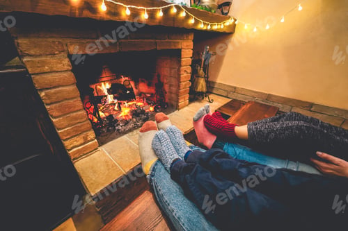 Preview: Legs View Of Happy Family Lying Down Next Fire Place Wearing Warm Wool Socks - Winter, Holiday