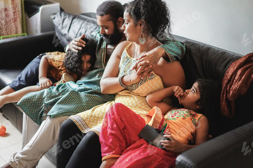 Preview: Happy Indian Family Having Fun At Home Sitting On Sofa - Soft Focus On Mother Face