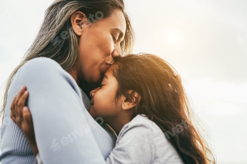 Preview: Happy Latin Mother And Daughter Having Tender Moment Together Outdoor - Focus On Mom Eye