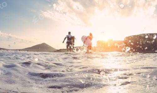 Preview: Surfers Couple Running With Surf Boards On The Beach - Sporty People Having Fun In Sunny Day