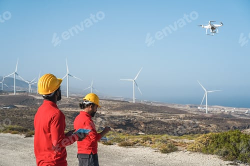 Preview: Multiracial Engineer Men Working On Windmill Farm With Digital Tablet And Drone - Renewable Energy