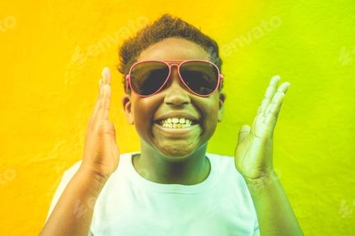 Preview: African Male Child Smiling And Wearing Sunglasses - Black Afro Kid Having Fun - Focus On Face