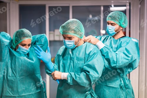 Preview: Doctors And Nurse Preparing To Work In Hospital For Surgical Operation During Coronavirus Pandemic