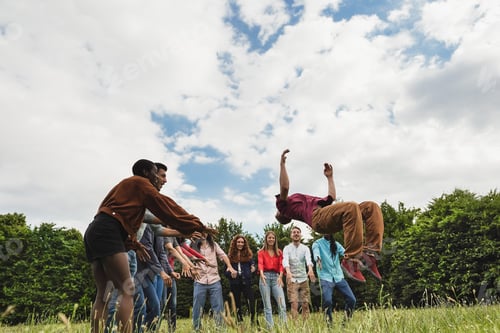 Preview: Young Multiracial Friends Having Fun Doing Stunts Outdoor