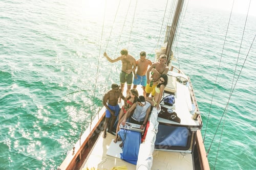 Preview: Group Of Young People Drinking And Dancing In Sailing Boat Party With Dj Playing Music - Top View
