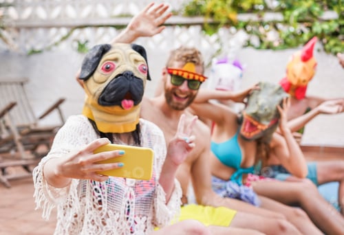 Preview: Happy Crazy Friends Having Fun Taking Selfie And Party Masks Sitting Next Swimming Pool - Young