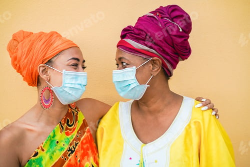 Preview: Happy African Mother And Daughter Wearing Safety Masks - Focus On Faces