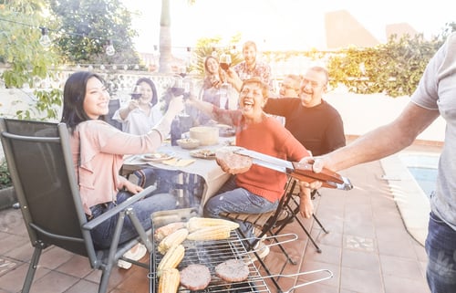 Preview: Man Cooking Cobs Of The Corn And Hamburgers At Barbecue Dinner Outdoor - Chef Grilling Food For Bbq