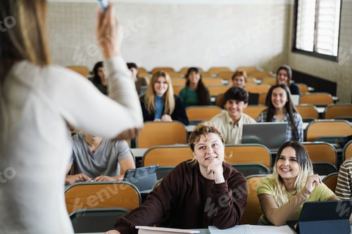 Preview: Mature Teacher Working With Students Inside Classroom At School University - Focus On Center Curvy