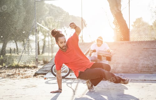 Preview: Trendy Man Making Video Feed Of His Breakdancer Friend Dancing In City Park Outdoor - Young People