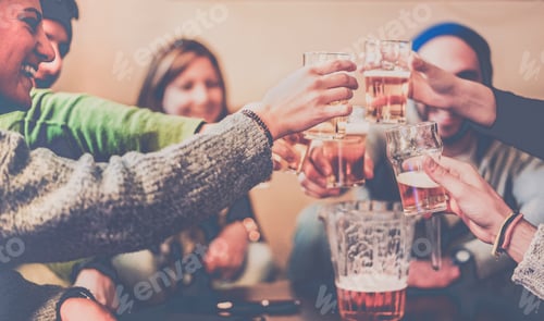 Preview: Happy Friends Toasting Beers And Laughing At Chalet Pub In Mountains - Young People Having Fun In