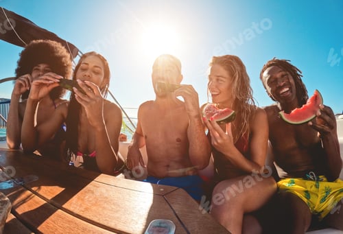 Preview: Happy Multiracial Friends Eating Watermelon While Doing Sea Tour With Sailing Boat - Summer And
