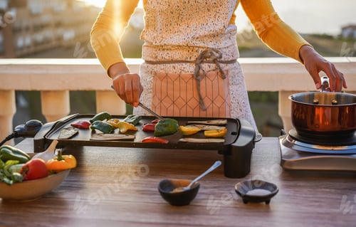 Preview: Young Woman Grill Vegetables While Preparing Dinner In Patio Terrace Outdoor During Isolation